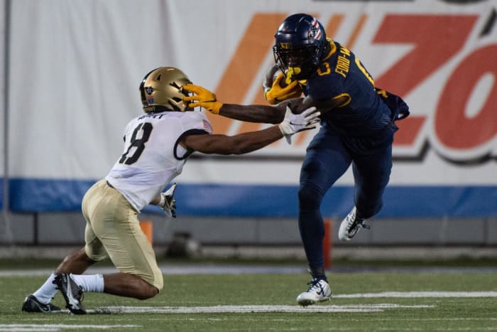 Dec 31, 2020; Memphis, TN, USA; West Virginia Mountaineers wide receiver Bryce Ford-Wheaton (0) carries the ball against Army Black Knights defensive back Javhari Bourdeau (8) during the second half at Liberty Bowl Stadium.